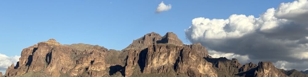 The Superstition Mountains under a blue sky with white clouds, Apache Junction, Arizona