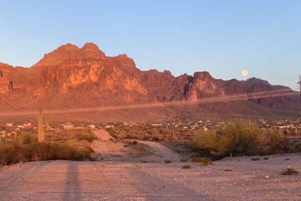 Moonrise over the Superstition Mountains above a desert road, Apache Junction