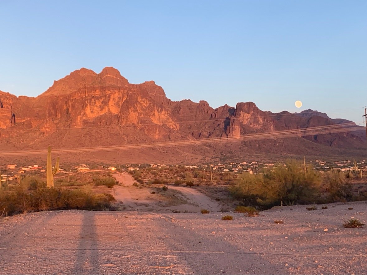 Moonrise over the Superstition Mountains above a desert road, Apache Junction